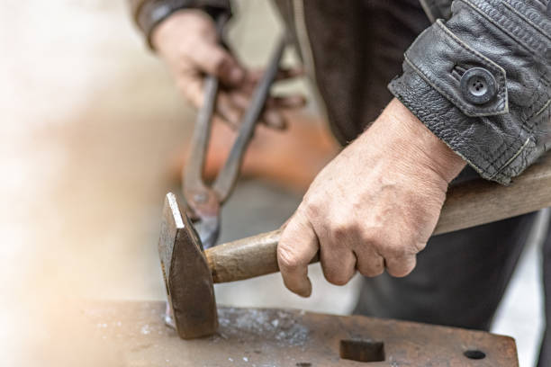 istock A blacksmith man forge a horseshoe on an anvil 1297611726