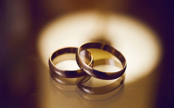 istock gold wedding rings on a glass surface. preparing for the wedding. close-up, macro 1297612443