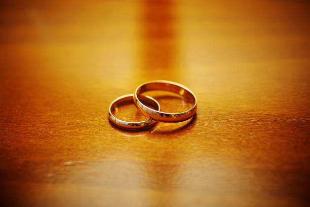 istock two wedding rings on a wooden surface. preparing for the wedding. close-up, macro 1297612471