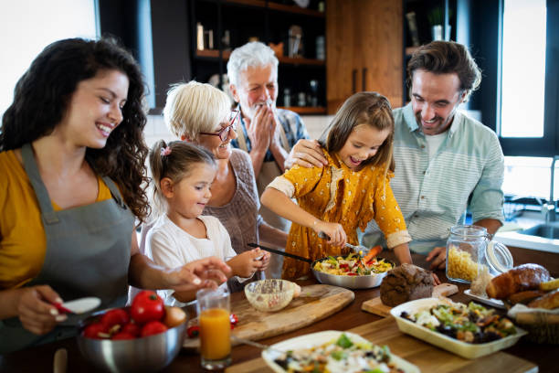 istock Cheerful family spending good time together while cooking in kitchen 1297613526