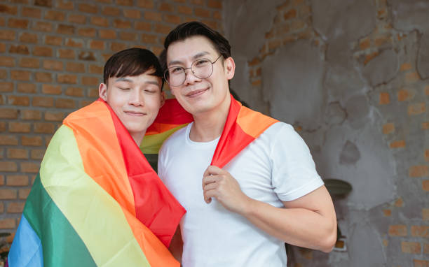 istock Portrait of two men with rainbow flag 1297614229