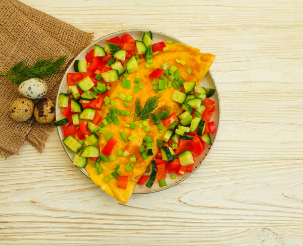 istock omelet, cucumbers, peppers on a wooden background 1297614446