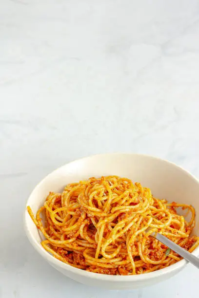 Italian Spaghetti Bolognese in a Bowl on White Background Top View