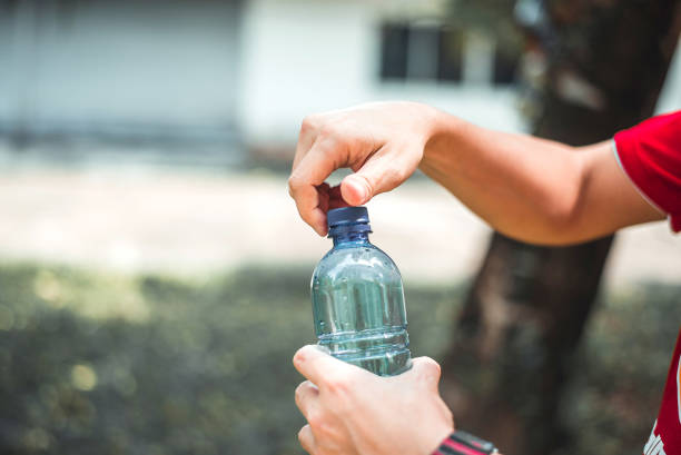 istock Man opening bottle of water 1297615697