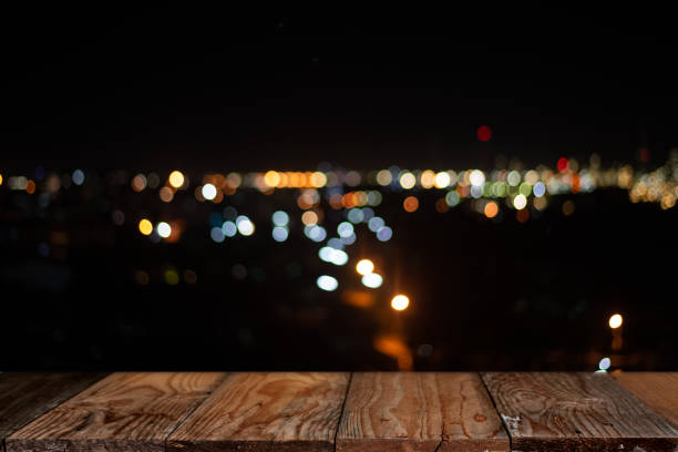 istock wooden table and abstract blurred background of bokeh lights 1297615774