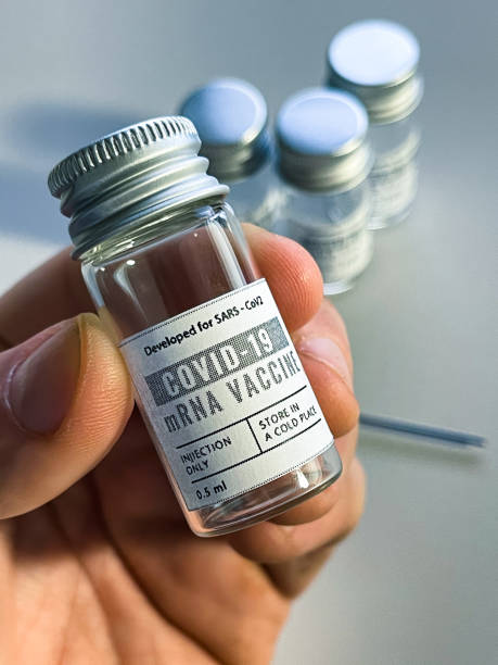 istock man holding a Covid19 vaccine vials 1297619100