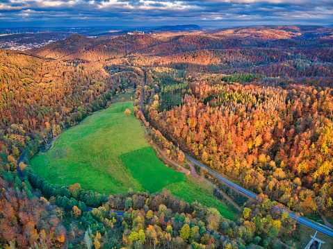 Aerial view over a deciduous forest in autumn with the famous Wartburg.
