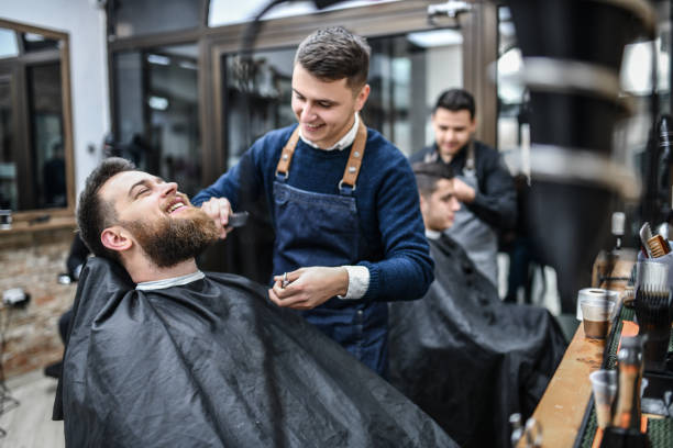 smiling barber combing customer's haircut - shaving men shaving cream mirror imagens e fotografias de stock