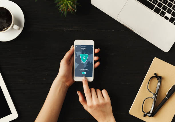 istock Woman holding and using smartphone with vpn app 1297622169