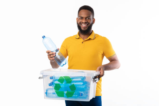 istock African Man Putting Plastic Bottle To Recycle Box, White Background 1297622776