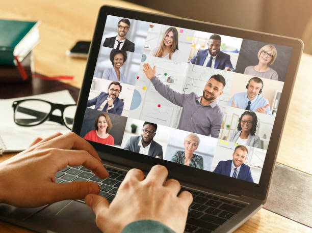 istock Businessman Video Calling Diverse Colleagues Via Laptop In Modern Office 1297622821