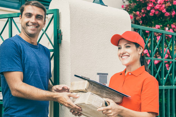 istock Happy male client receiving order form female courier 1297623561