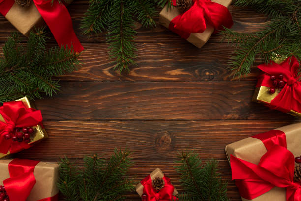 istock Christmas background with decorations and gift boxes on wooden table. Top view. Copy space.  Merry christmas and happy new year 1297624263