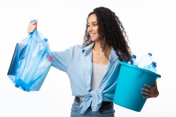 istock Lady Holding Plastic Garbage Bag And Bucket Posing In Studio 1297624632