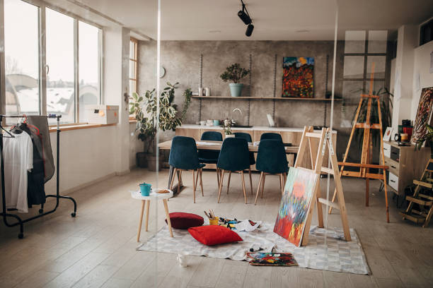 istock Modern painting by the ladder in empty apartment 1297625684