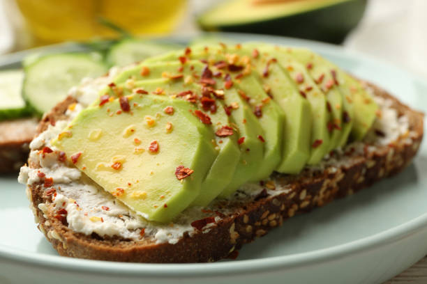 istock Concept of breakfast with toast with avocado, close up 1297625703