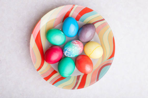 istock Easter holiday with colorful eggs on a plate while cooking. Homemade baking. 1297625906