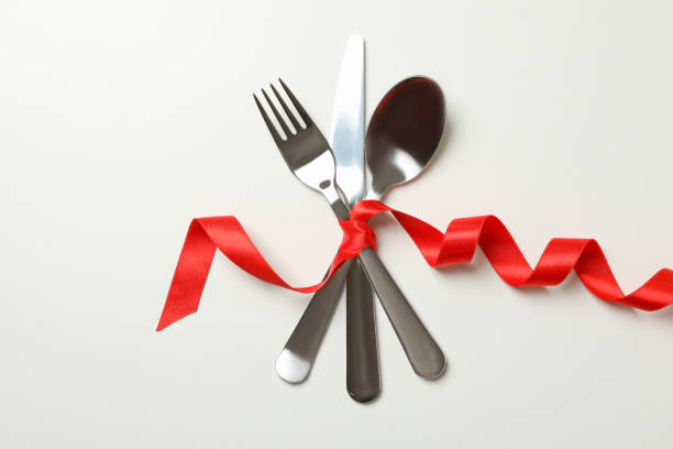 istock Cutlery with red ribbon on white background 1297626962