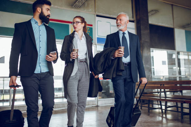 istock Business people with luggage at train station 1297627356