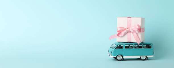 istock Toy bus with gift box on blue background 1297627432