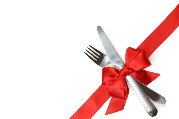 istock Cutlery with red bow isolated on white background 1297627622