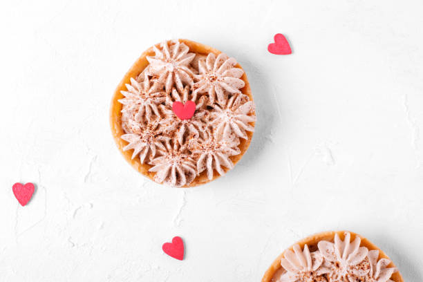 istock Mini Banoffee pie topped with sugar heart on the white table 1297627643