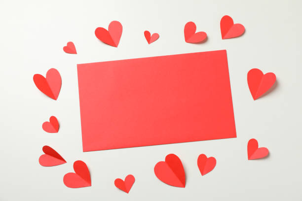 istock Empty red paper and decorative hearts on white background 1297627695