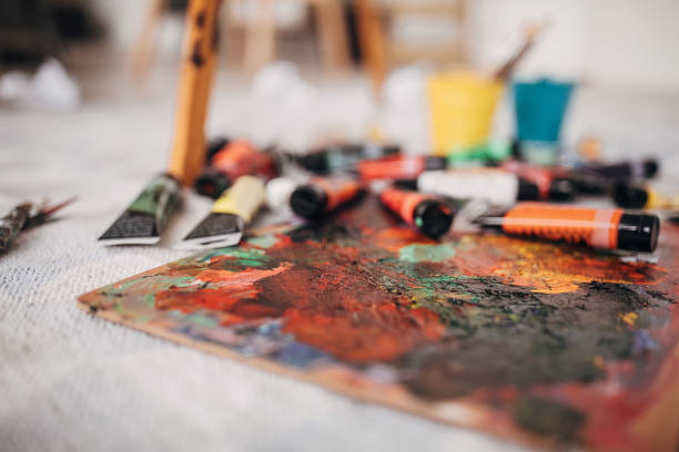 istock Messy paint tubes and paintbrushes on the floor 1297627727