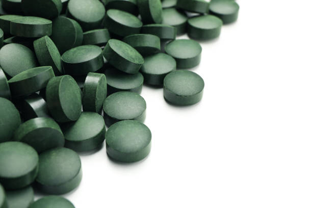 Organic spirulina powder and tablets shot on a slate 
