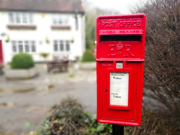 istock Traditional British red public mailbox in the countryside 1297628567