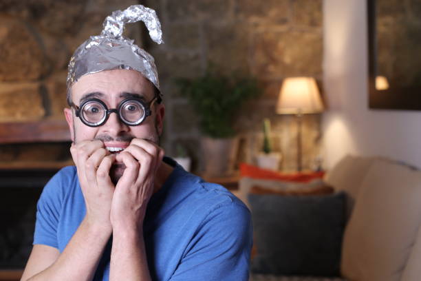 istock Shocked man wearing weird tinfoil hat 1297629923