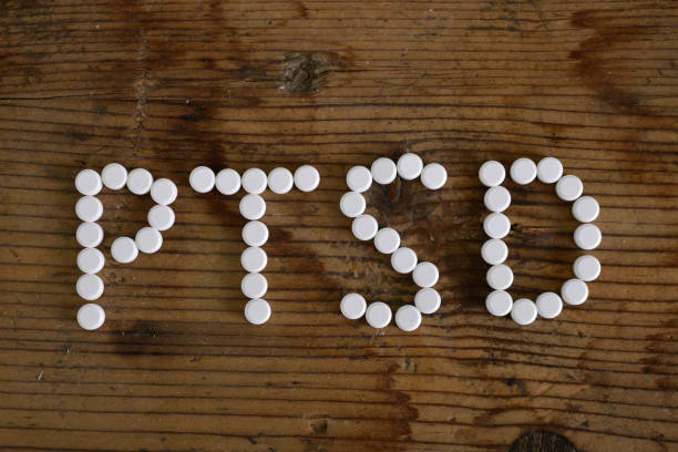 istock text Ptsd. writing with pills on wooden table . Concept meaning Post Traumatic Stress Disorder Mental Illness Trauma Fear Depression 1297630058