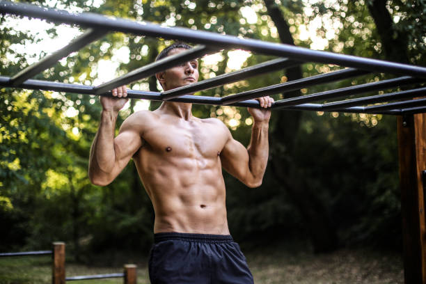 istock Young man exercising chin-ups 1297630081