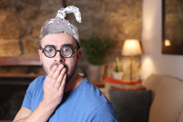 istock Shocked man wearing weird tinfoil hat 1297630253
