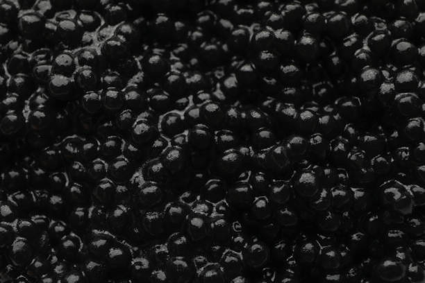 istock Fresh black caviar on whole background, close up 1297631502