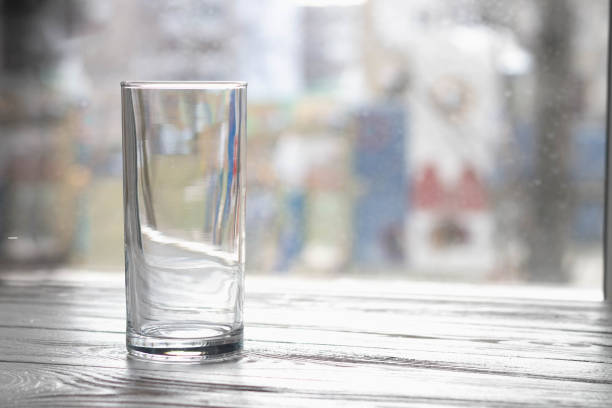 istock An empty clear glass tumbler on the table by the window 1297631567