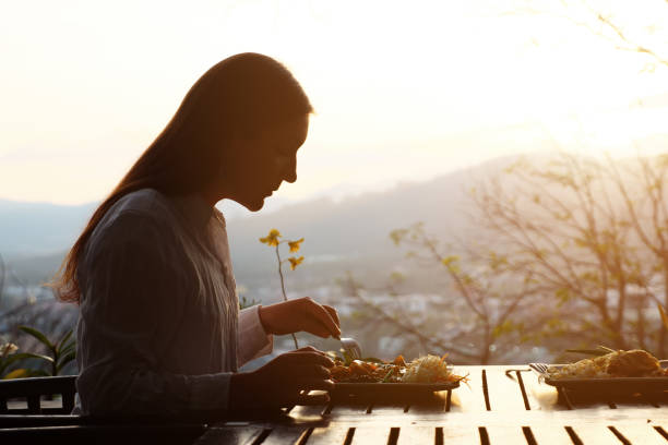 istock Brunette woman eating in a cafe with a beautiful view 1297631793