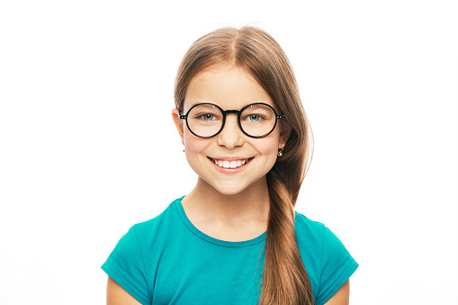 Vision correction for children. Smiling child with stylish eyeglasses isolated on white background
