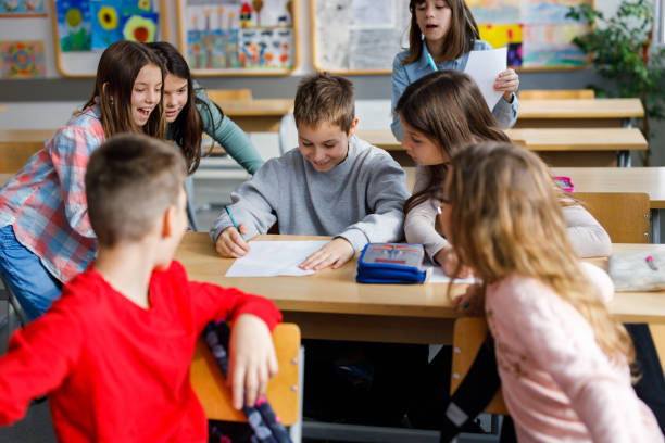 istock Smart student shares his knowledge with classmates in the classroom 1297632887
