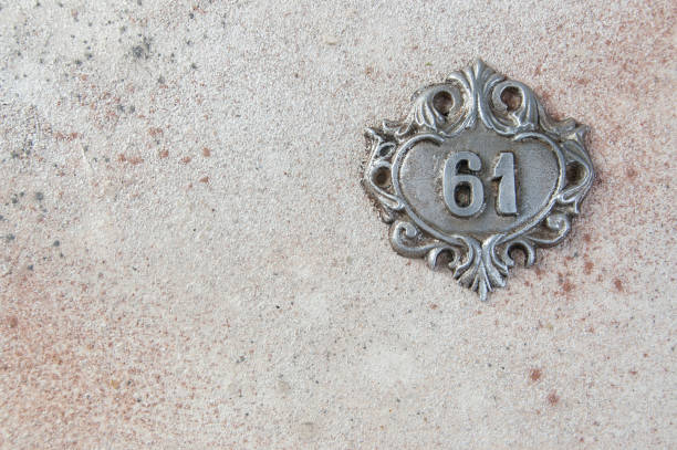 istock Old aluminum number on concrete background 1297632904