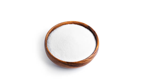 istock Salt in a wooden bowl isolated on a white background 1297632962
