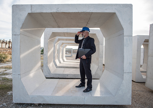 Industrial inspector checks the quality of the concrete structures and frames used for the construction of bridges and aqueducts