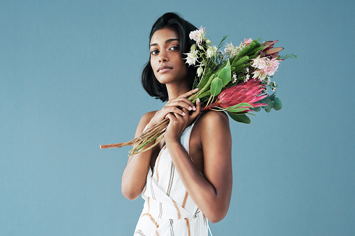 Cropped shot of a beautiful young woman posing with a bouquet of flowers