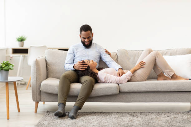 istock African american couple spending weekend together lying on couch 1297634399
