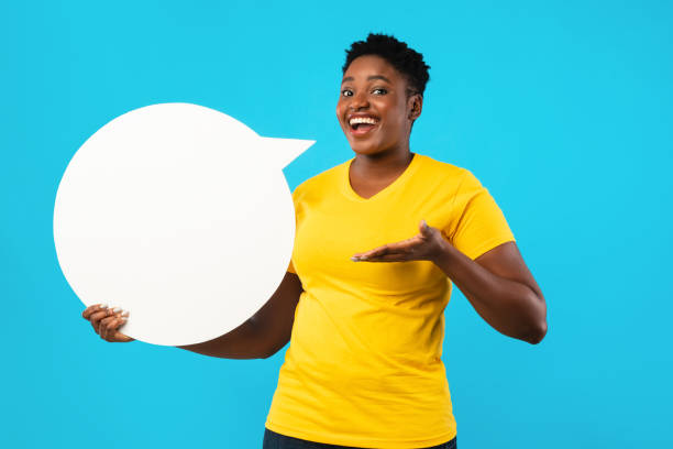 istock Happy Black Lady Posing With Speech Bubble Over Blue Background 1297634425