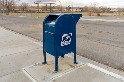Oro Grande, CA, USA – January 19, 2021: A United States Postal Service curbside collection box in the rural town of Oro Grande, California.