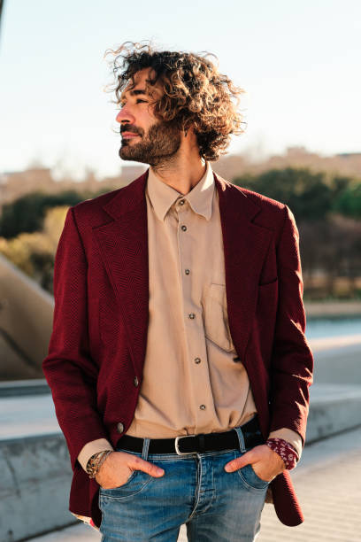 istock Hipster man dressed stylishly standing outdoors. 1297635378