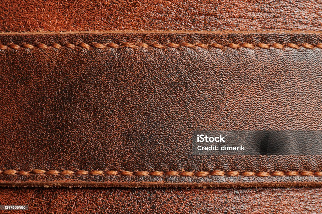 Brown leather tag Brown leather tag with stitches macro close up view Leather Stock Photo