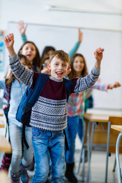 istock Group of children having fun while jumping and screaming in the classroom 1297635531