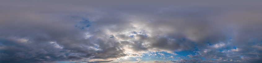 Dark blue sunset sky with Cumulus clouds. Seamless hdr panorama in spherical equirectangular format. Complete zenith for use in 3D, game and as sky replacement for aerial drone 360 panoramas